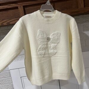 Elegant Cream Sweater with Bow Detail